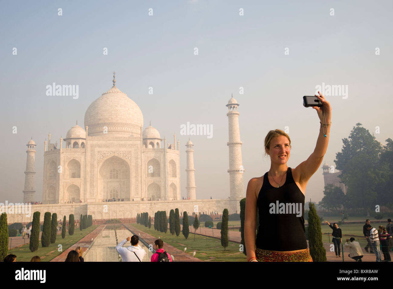 Una donna prende un selfie davanti al Taj Mahal in Agra India Foto Stock