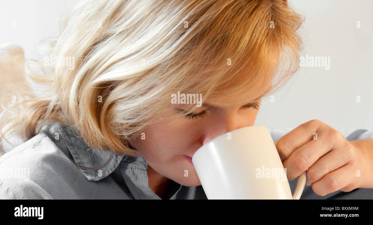Donna di bere dalla tazza di caffè Foto Stock