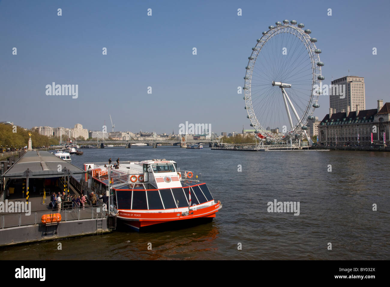 Battello da crociera sul Tamigi da Westminster Bridge con il London Eye in background Foto Stock