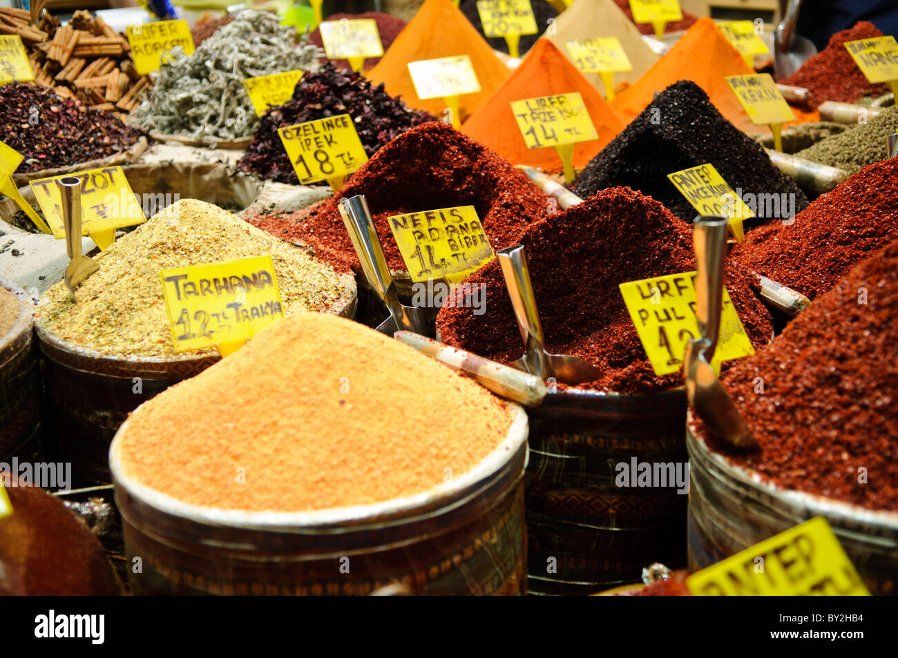 Il Bazar delle spezie e delle erbe Istanbul Turchia // ISTANBUL, Turchia — colorate montagne di spezie tradizionali riempiono le bancarelle dei venditori presso il Bazaar delle spezie (noto anche come Mısır Çarşısı o Bazaar egiziano). Originariamente costruito nel 1660 come parte della vasta rete commerciale delle spezie dell'Impero ottomano, il bazar fu costruito per generare entrate per il vicino complesso della nuova Moschea. Il mercato coperto a forma di L contiene circa 85 negozi specializzati in spezie, erbe aromatiche, delizie turche, frutta secca e altri prodotti culinari tradizionali. Situato nel quartiere di Eminönü, vicino al Corno d'Oro, il bazar co Foto Stock