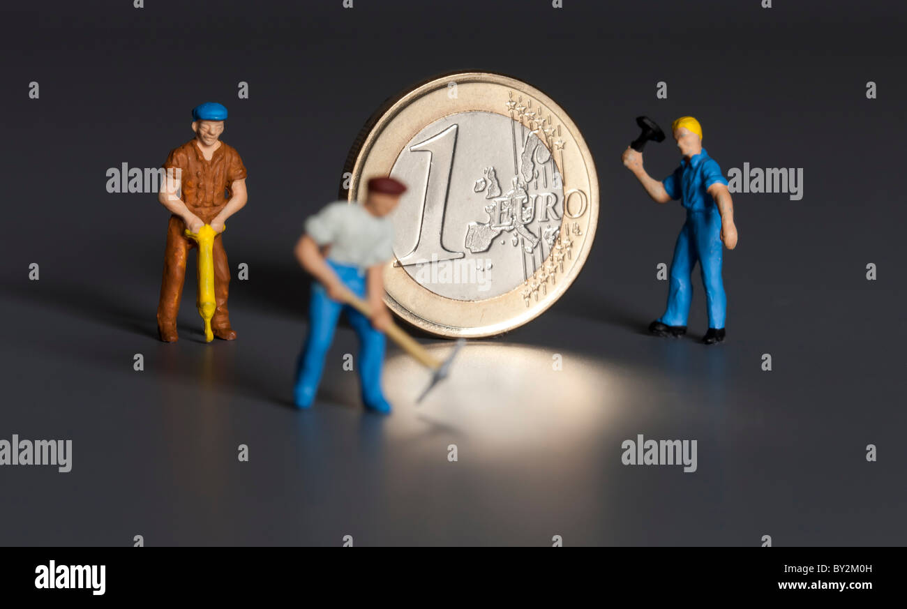 1 monete in euro con i lavoratori Foto Stock