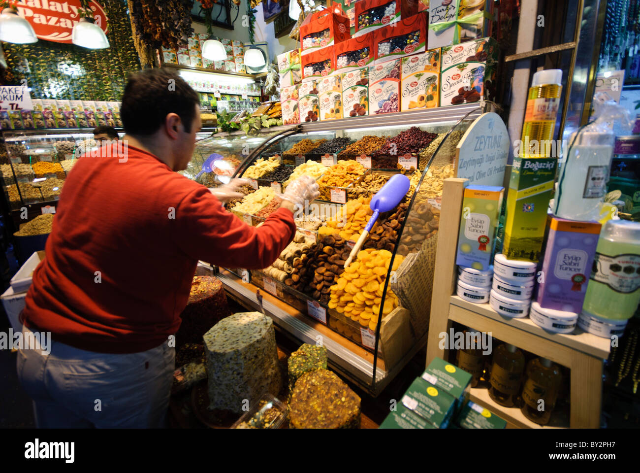 Spice Bazaar Dried Fruits and Nuts Vendor Istanbul // ISTANBUL, Turchia — Un venditore vende frutta secca e noci nel Bazaar delle spezie (noto anche come Bazaar egiziano) a Istanbul. Il Bazar delle spezie, costruito nel 1660, è uno dei più antichi mercati coperti di Istanbul e tradizionalmente è servito come centro del commercio delle spezie tra Europa e Asia. Situato nel quartiere di Eminönü vicino al Corno d'Oro, il bazar ospita decine di negozi che vendono spezie, delizie turche, frutta secca, frutta secca, frutta secca e altri prodotti tradizionali. Il mercato è stato originariamente costruito come parte del complesso della nuova Moschea ed è stato storico Foto Stock