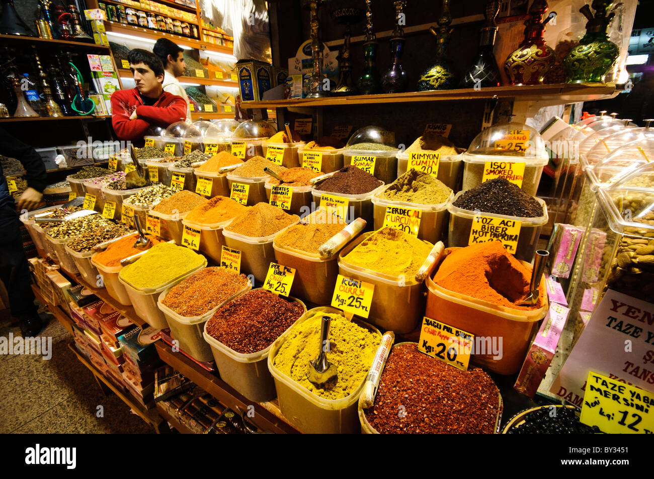 Un bottegaio attende i clienti accanto al suo display di spezie disponibili per la vendita presso il famoso Bazar delle Spezie (noto anche come il Bazaar Egyption) ad Istanbul in Turchia. Foto Stock