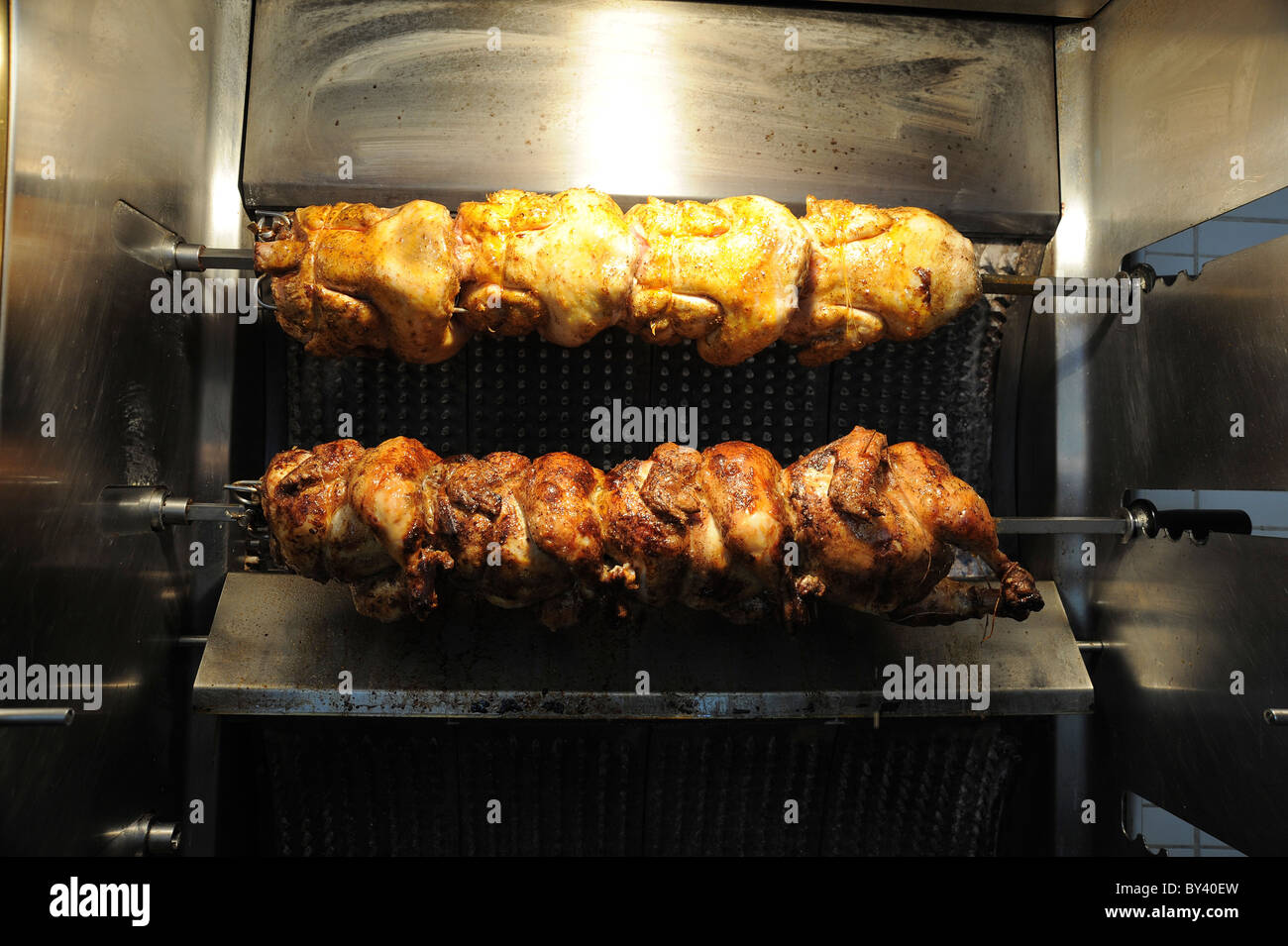 Tutto il pollo alla griglia su uno spiedino Foto Stock