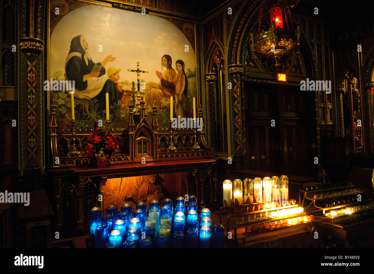 MONTREAL, Canada - Una cappella laterale nella basilica di Notre-Dame presenta un dipinto di Santa Margherita Bourgeoys, la prima insegnante a Montreal e fondatrice della Congregazione di Notre Dame. Bourgeoys, che fondò la prima scuola di Montreal nel 1658, fu canonizzata nel 1982 per il suo lavoro pionieristico nell'educazione coloniale. La cappella serve come tributo al suo ruolo significativo nel patrimonio cattolico ed educativo di Montreal. Foto Stock