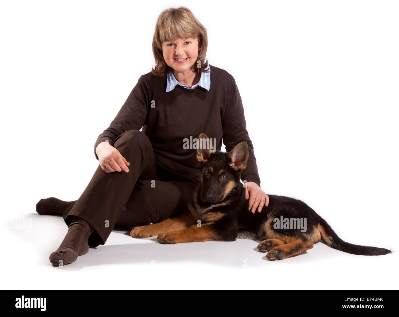 Una signora con un tredici settimane vecchio pastore tedesco cucciolo di cane Foto Stock