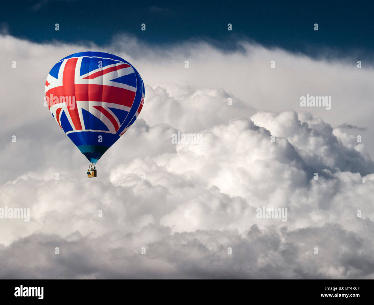 Una mongolfiera con una bandiera europea motif battenti di fronte drammatico nuvole di tempesta Foto Stock