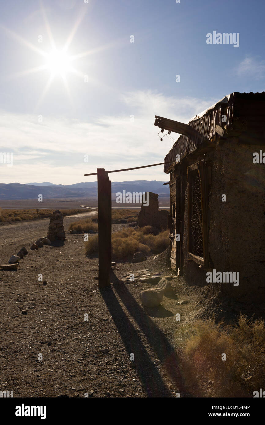 Sunburst e ruderi di edifici abbandonati nella Valle della Morte di Ghost Town Ballarat, California, Stati Uniti d'America. Foto Stock