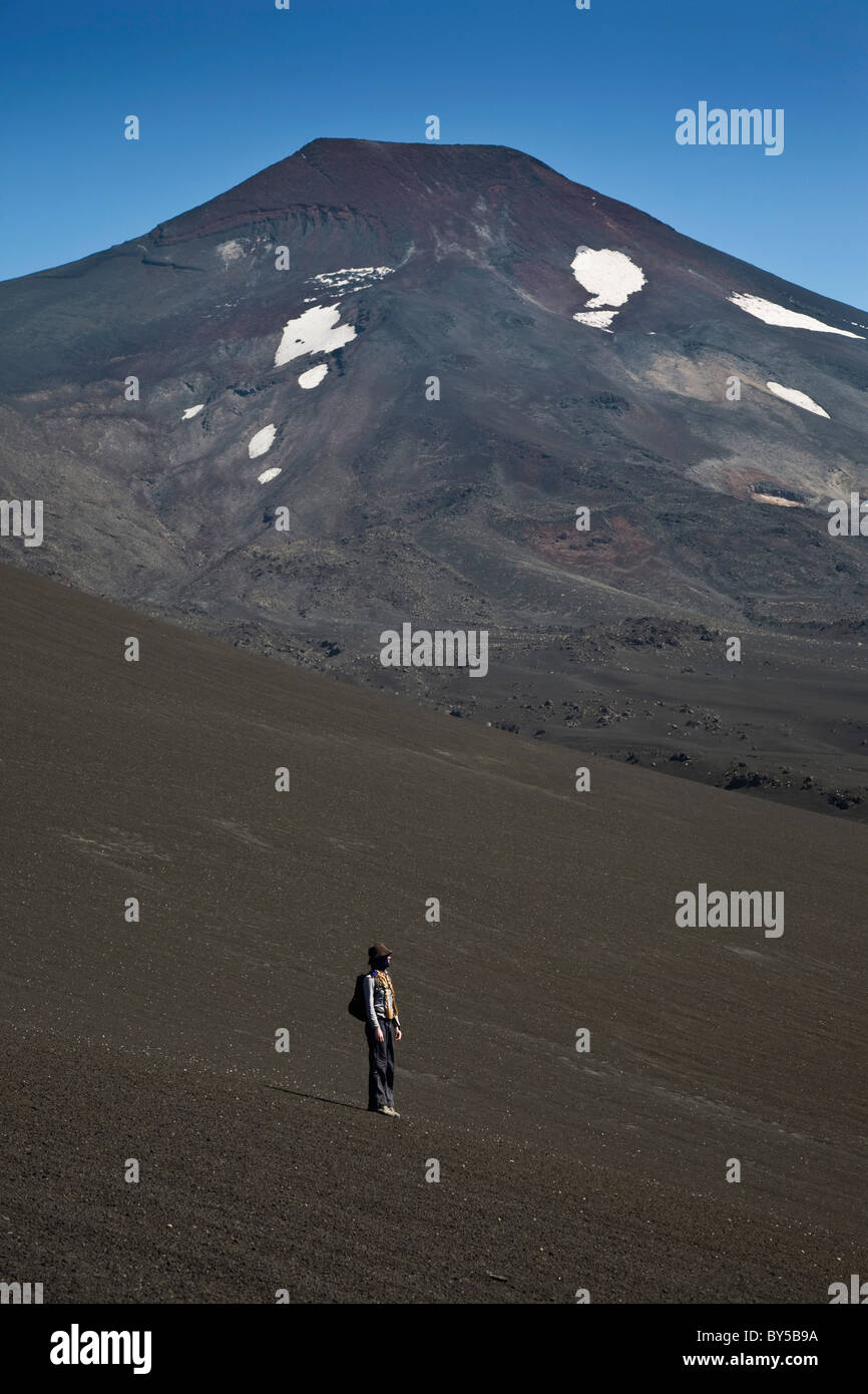 Una donna in piedi sul vulcano Lonquimay, Patagonia, Cile Foto Stock