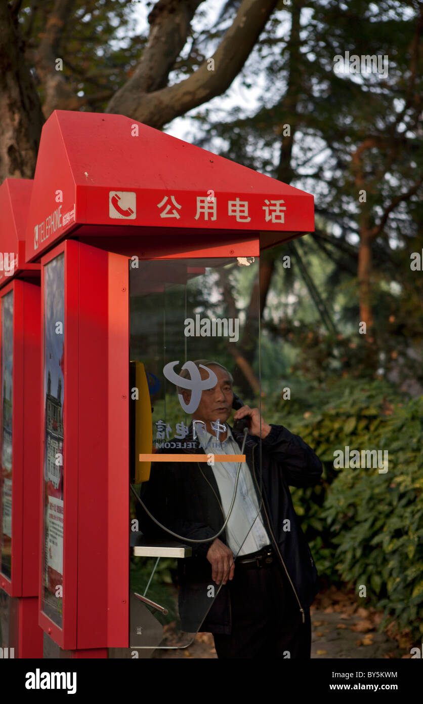 Uomo al telefono pubblico a Luxor Park, Shanghai Cina Foto Stock