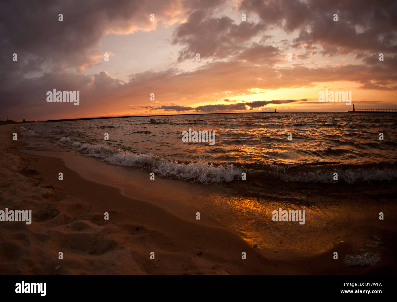 Spiaggia tramonto sul lago michigan onde faro di sabbia Foto Stock