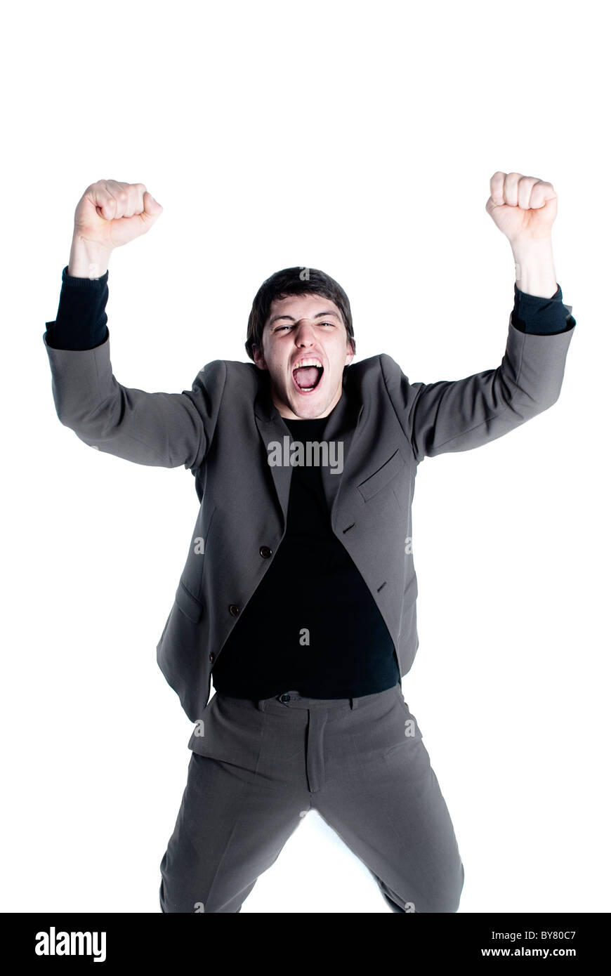 Giovane imprenditore con in alto le mani e il viso di vittoria, felice, euforico Foto Stock