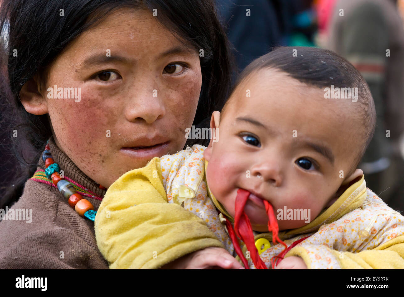 Il Tibetano la madre e il bambino il bambino per il Barkhor Lhasa il Tibet. JMH4685 Foto Stock