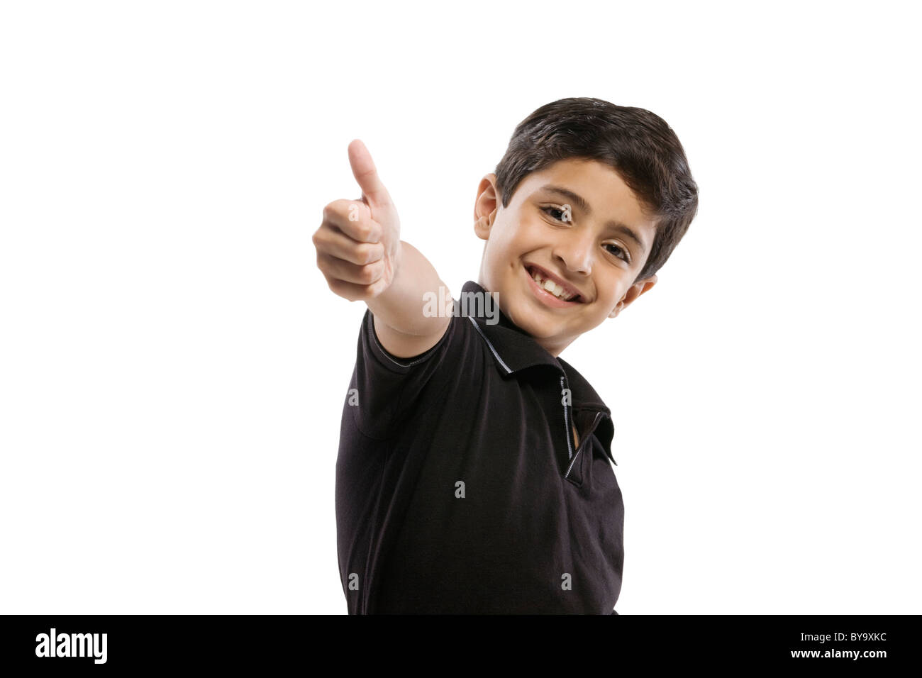 Ragazzo giovane dando un pollice in alto Foto Stock