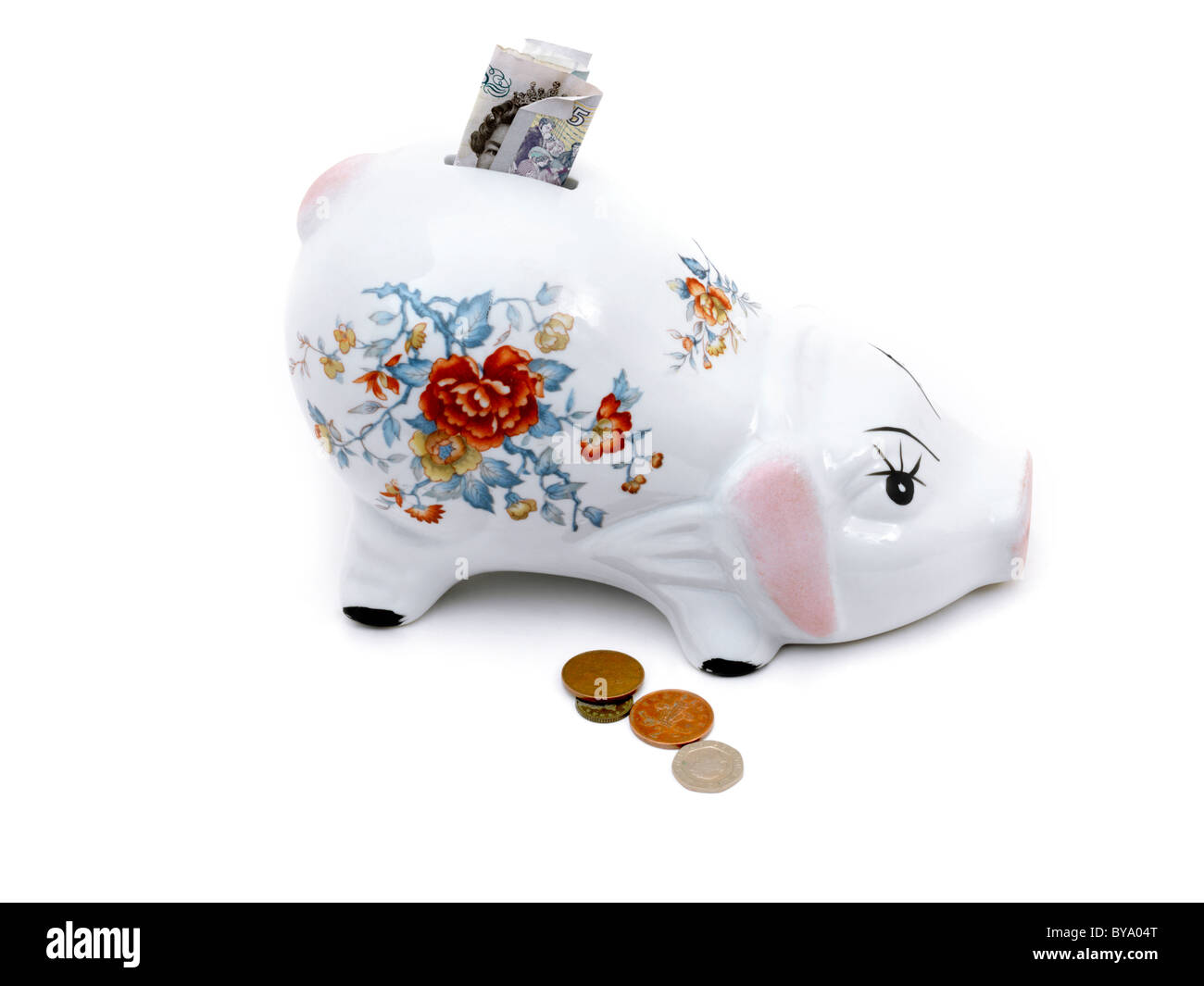 Cinque Pound nota nel salvadanaio e monete Foto Stock