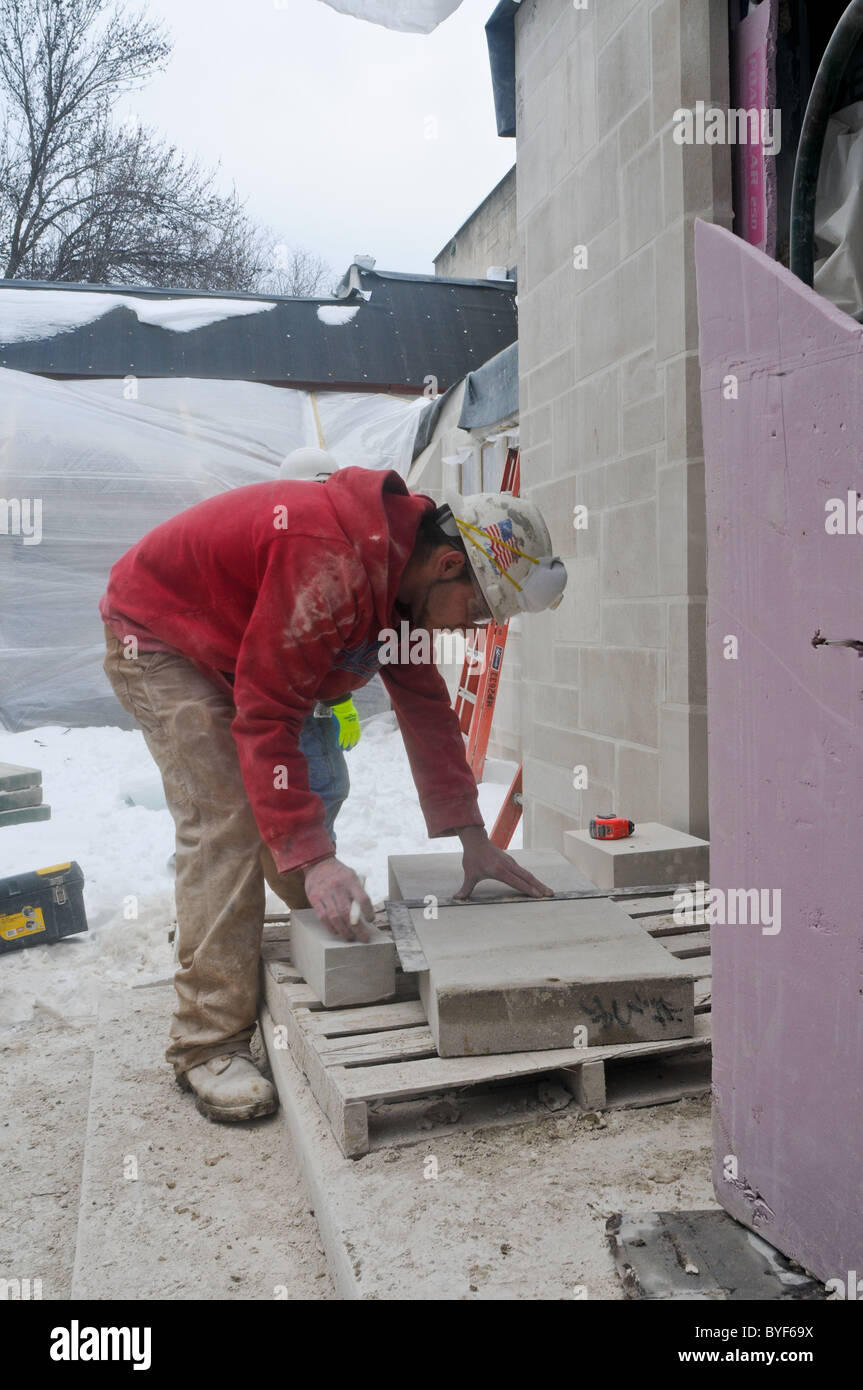 In inverno il lavoro di costruzione con pietra da taglio Foto Stock