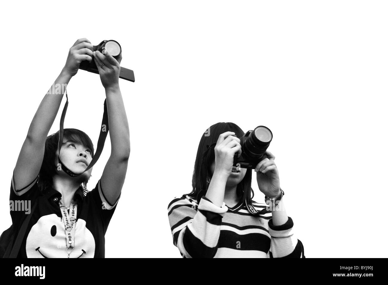 Bianco e nero ritratto di due giovani asiatici fotografi femmina Foto Stock