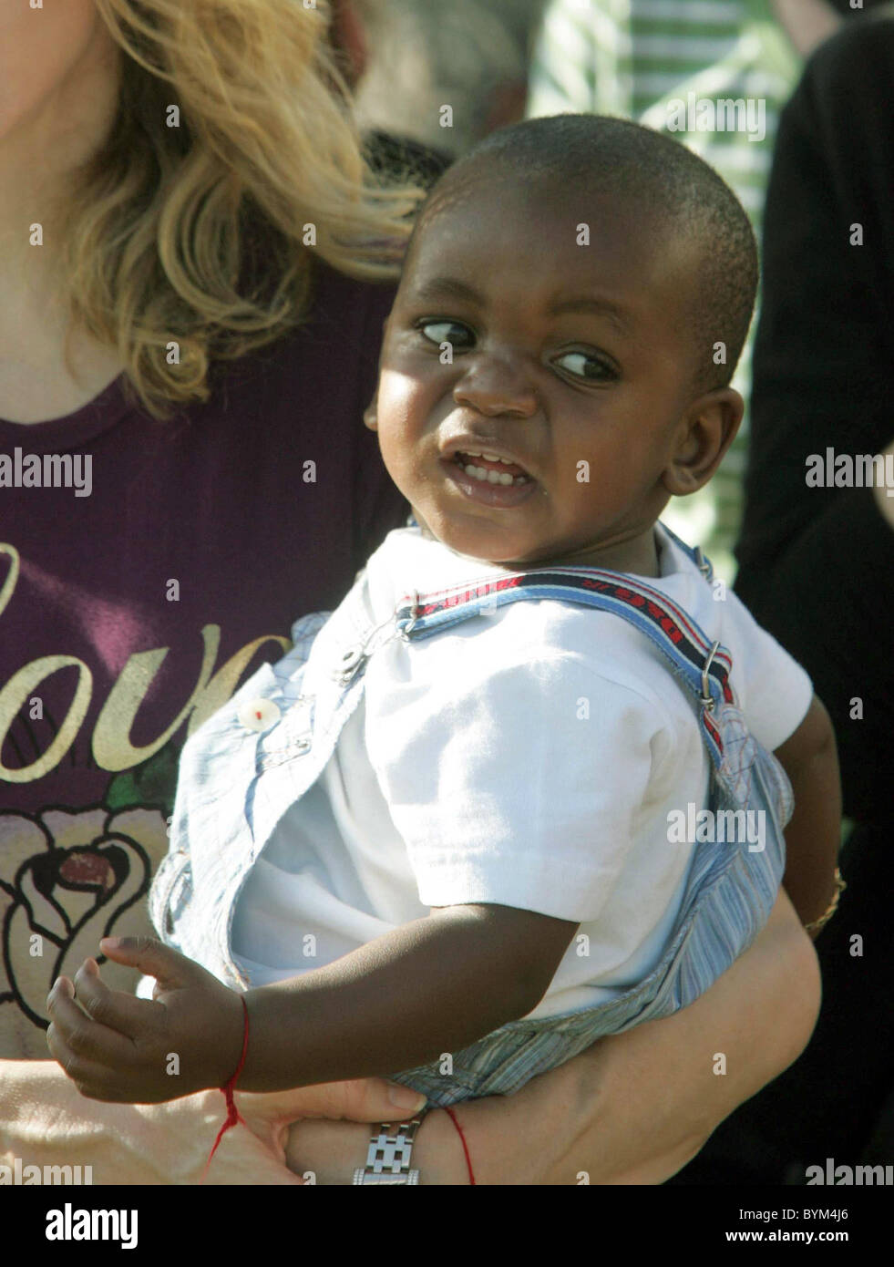 David Banda Madonna indossa un marrone rossiccio T-Shirt con 'amore' e  azienda baby David Banda durante una visita in un orfanotrofio e ha  esortato Foto stock - Alamy