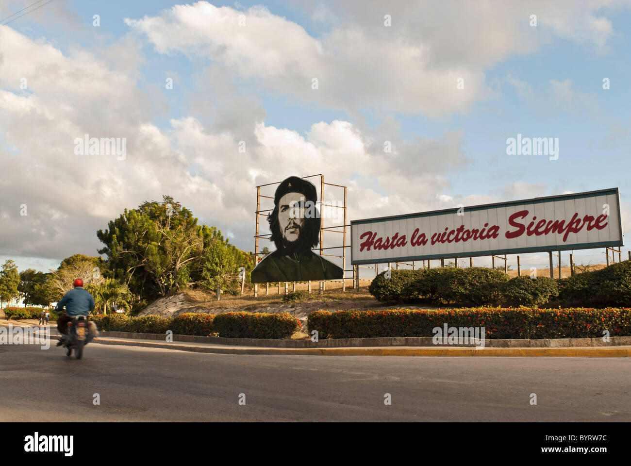 La moto la guida su una strada vicino a Las Tunas vicino a che la propaganda di bill. Las Tunas, Cuba, dei Caraibi. Foto Stock