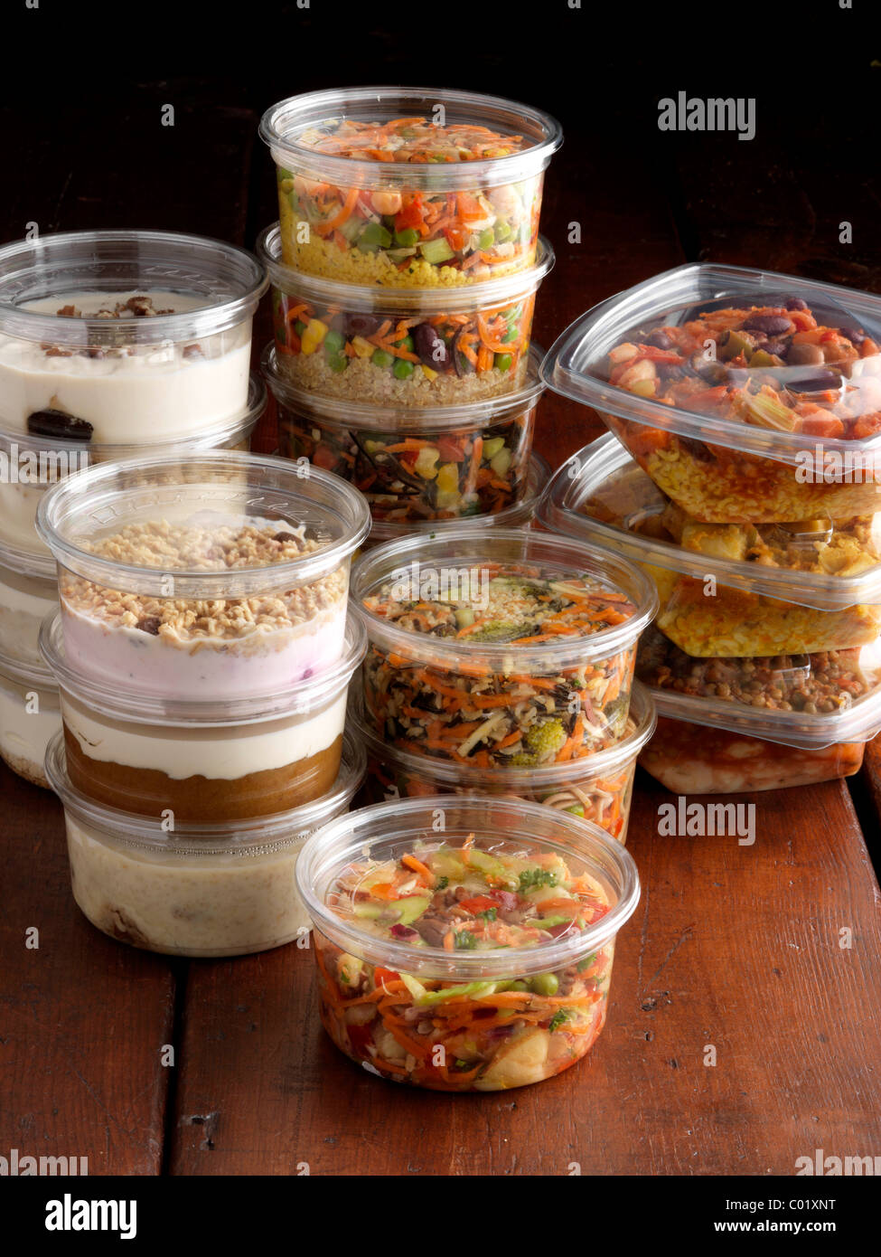 Piatti vegetariani insalate e dessert in vasi di plastica per asporto Foto Stock