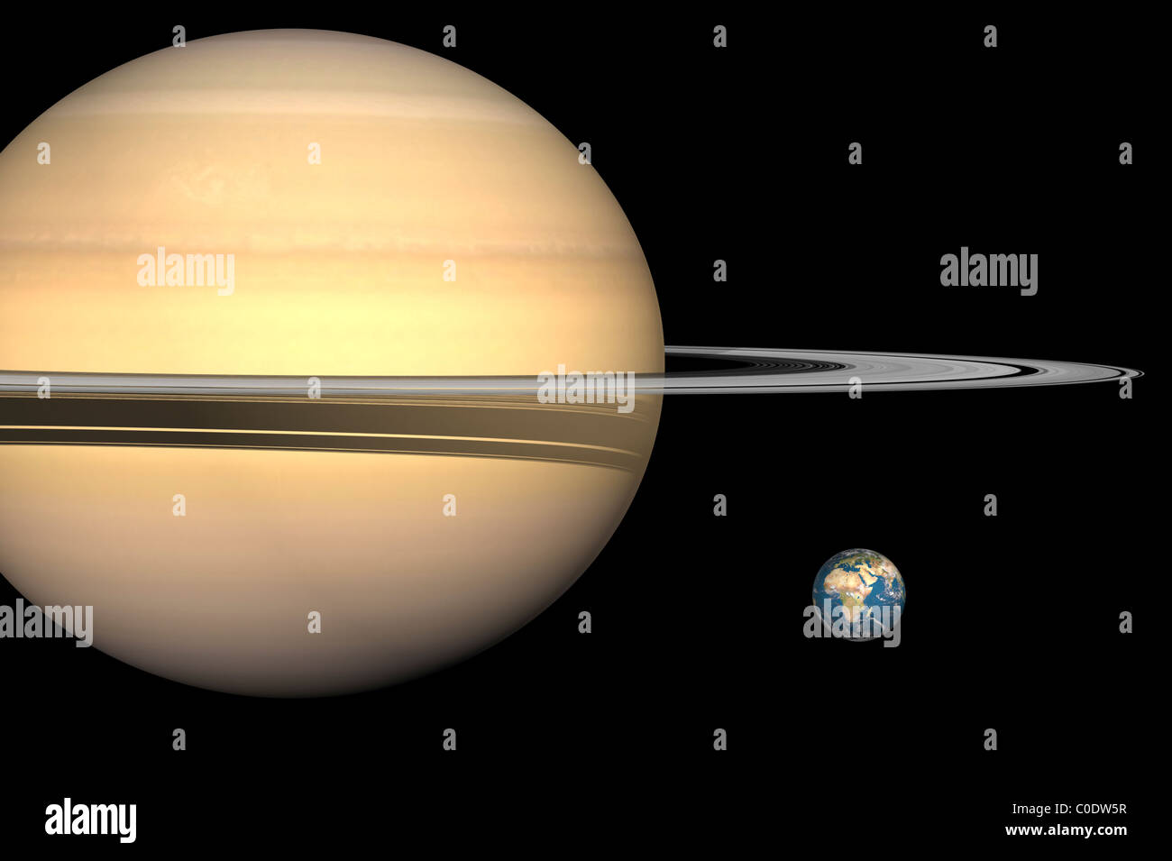 Illustrazione di Saturno e la terra in scala. Foto Stock