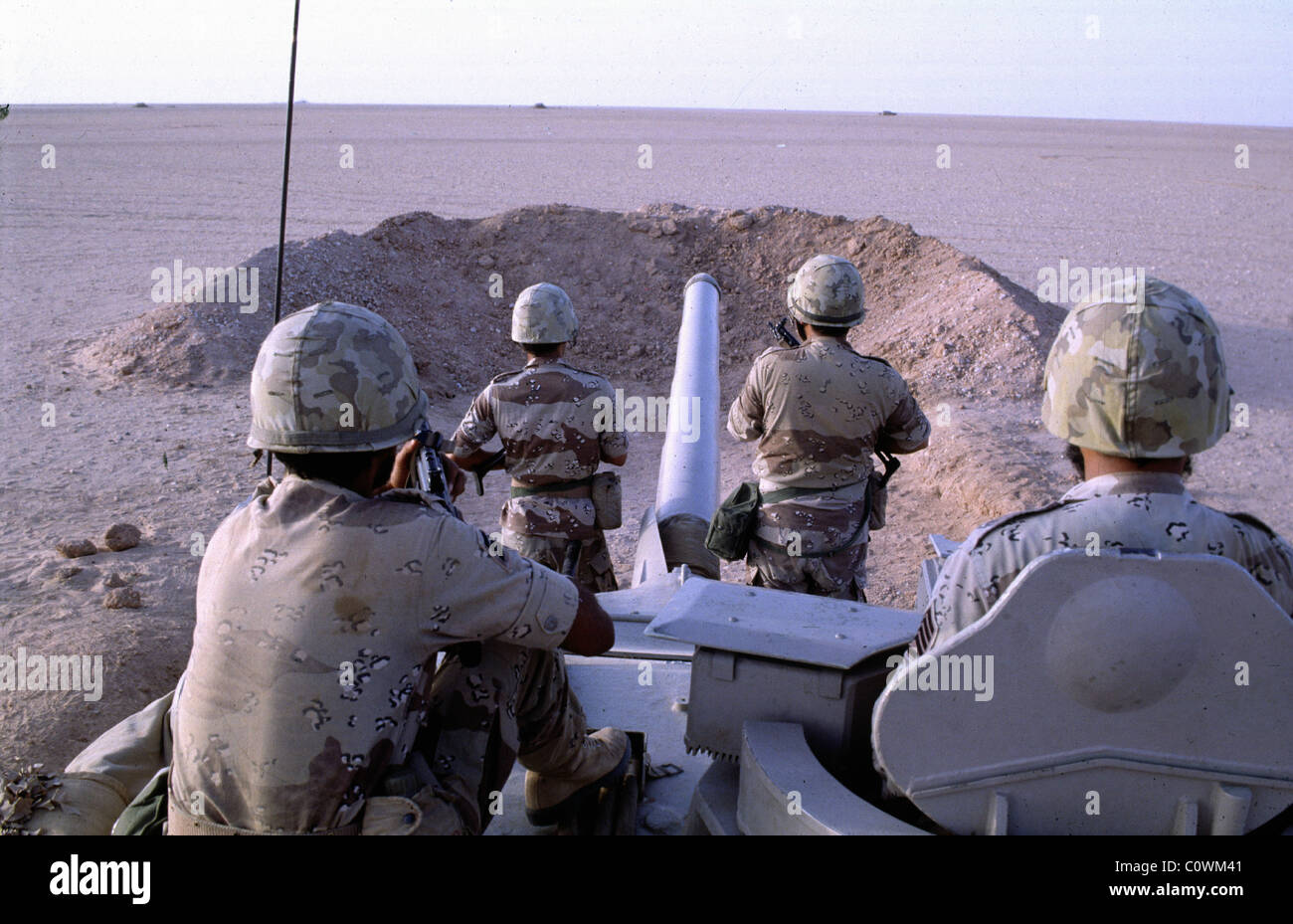 Arabia soldati uomo un serbatoio dietro la sabbia bluff, rivolta verso le forze irachene appena al di là del deserto dove risiede l'Arabia confine iracheno, Foto Stock