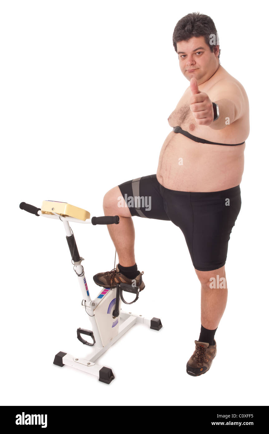 Fat Man facendo allenamento in bicicletta statica Foto Stock