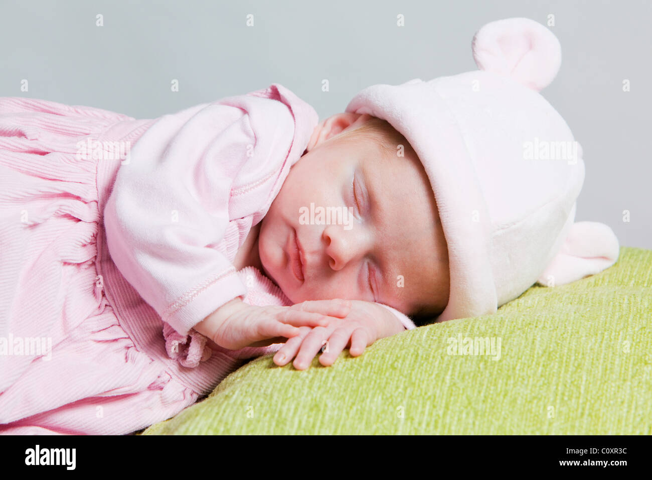 5 settimana di età bambina addormentata indossando un cappello di lana Foto Stock