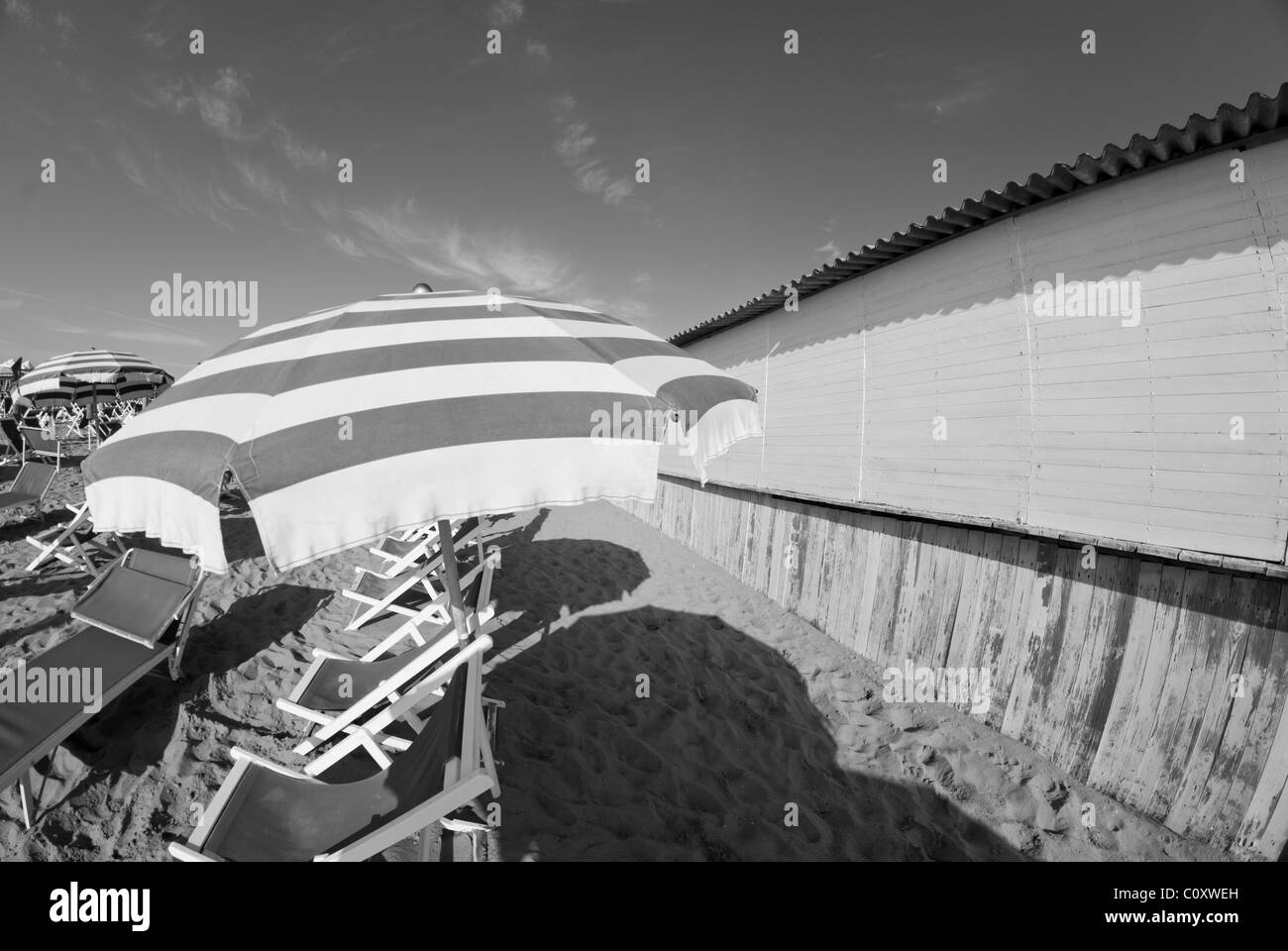 Ombrelloni sulla riva, costa italiana Foto Stock