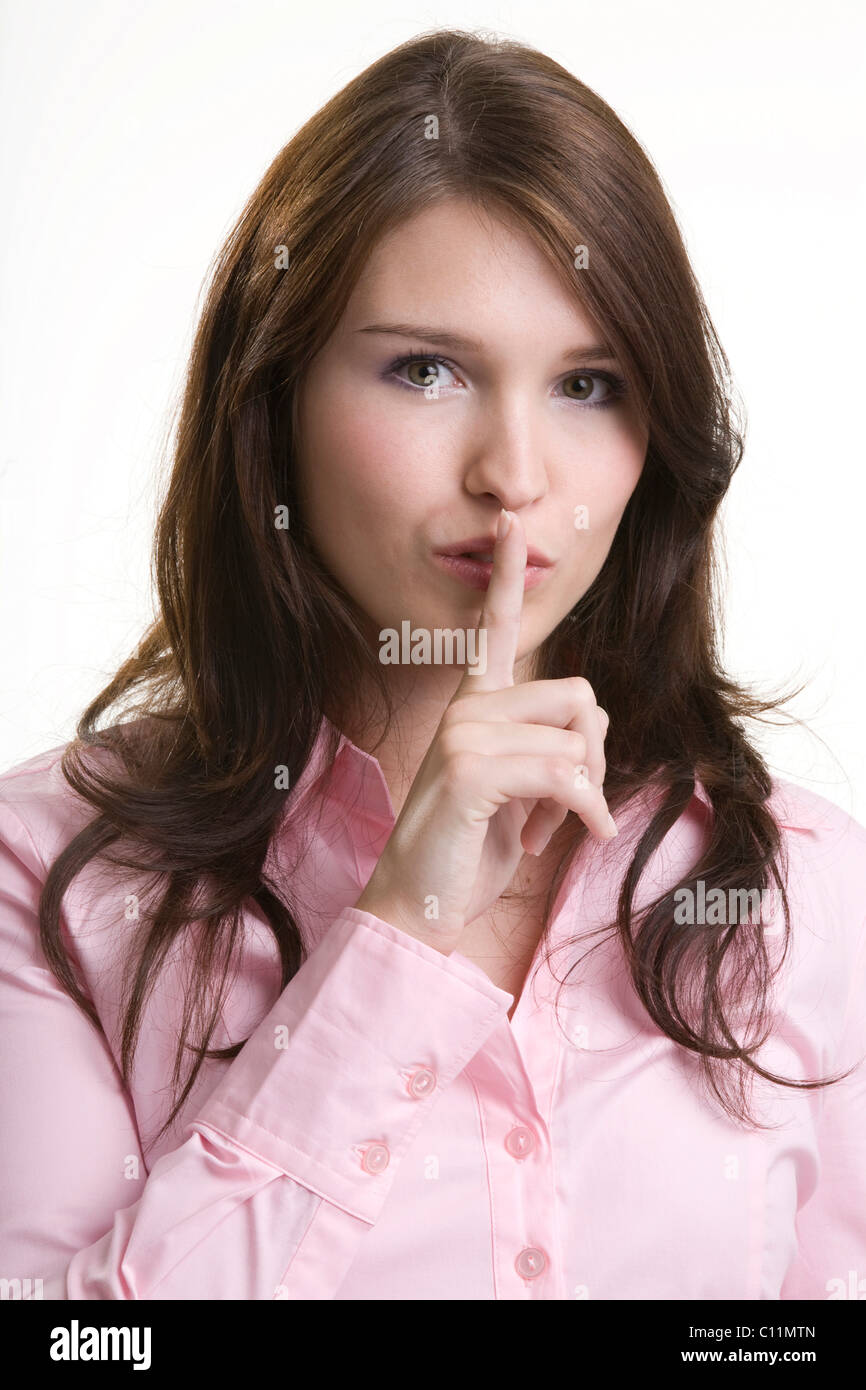 Giovane donna, gesti di silenzio, segretezza Foto Stock