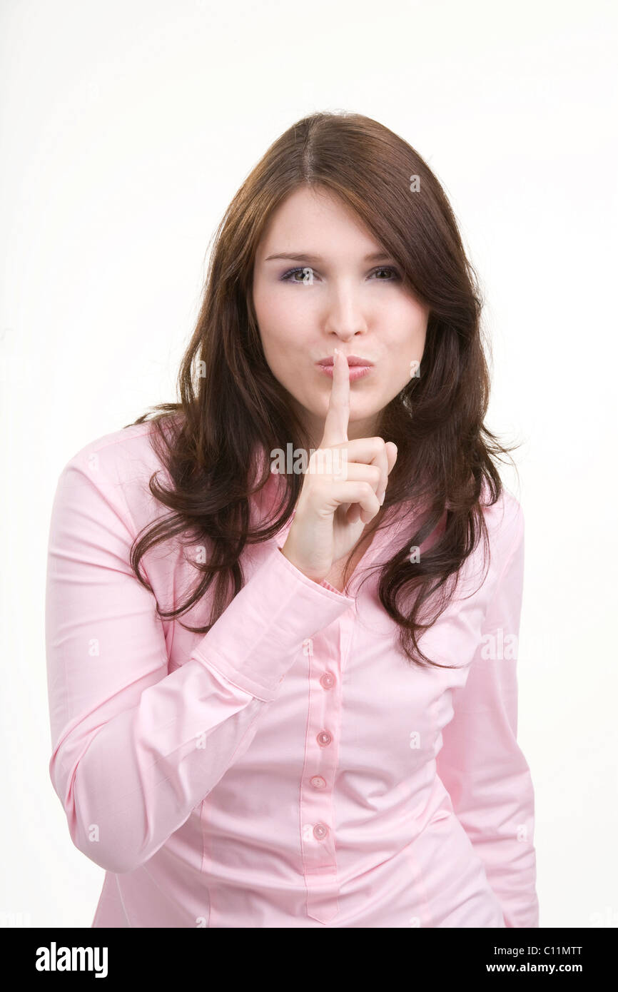 Giovane donna, gesti di silenzio, segretezza Foto Stock