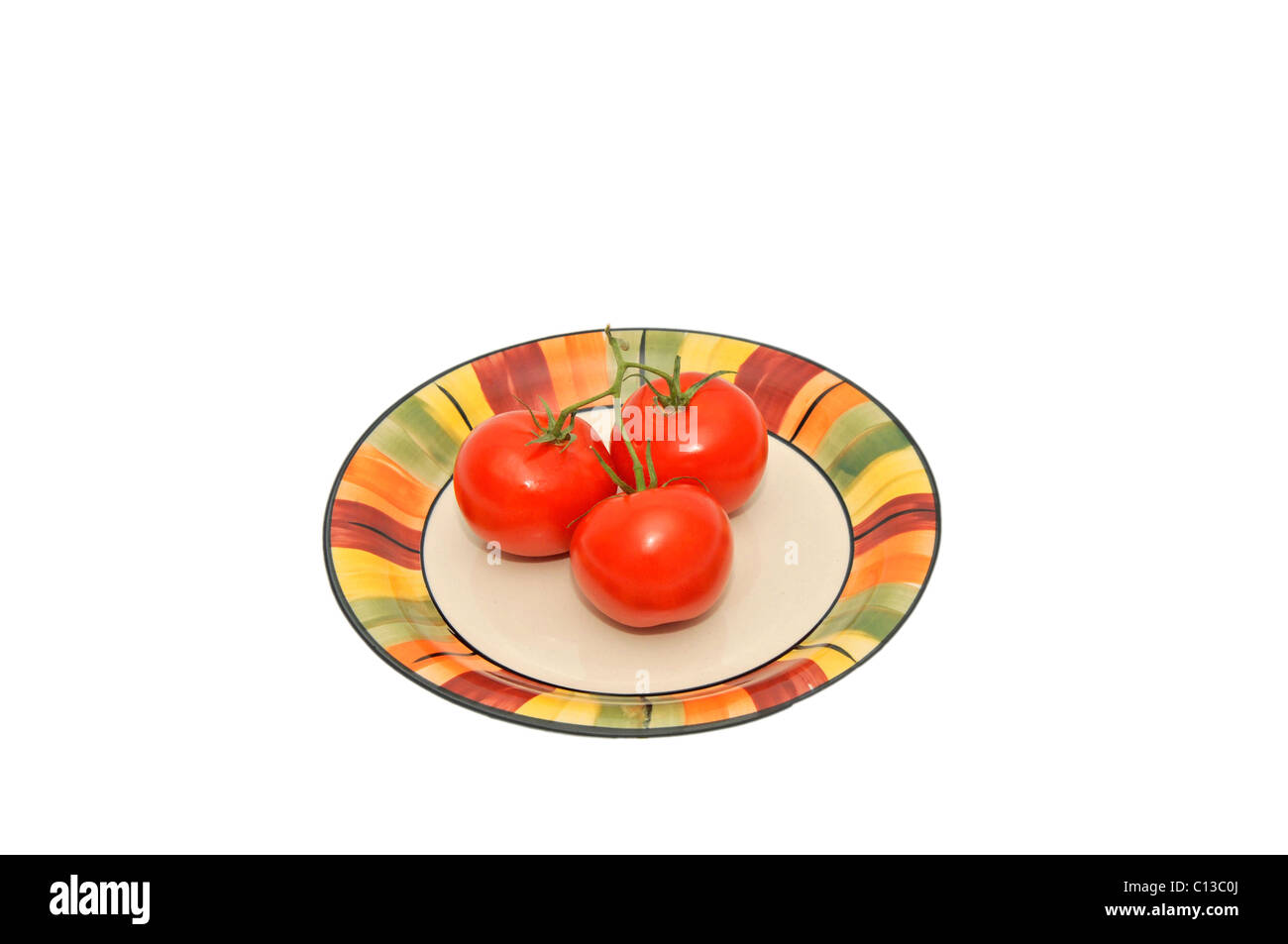 Tre i pomodori sulla piastra colorati Foto Stock