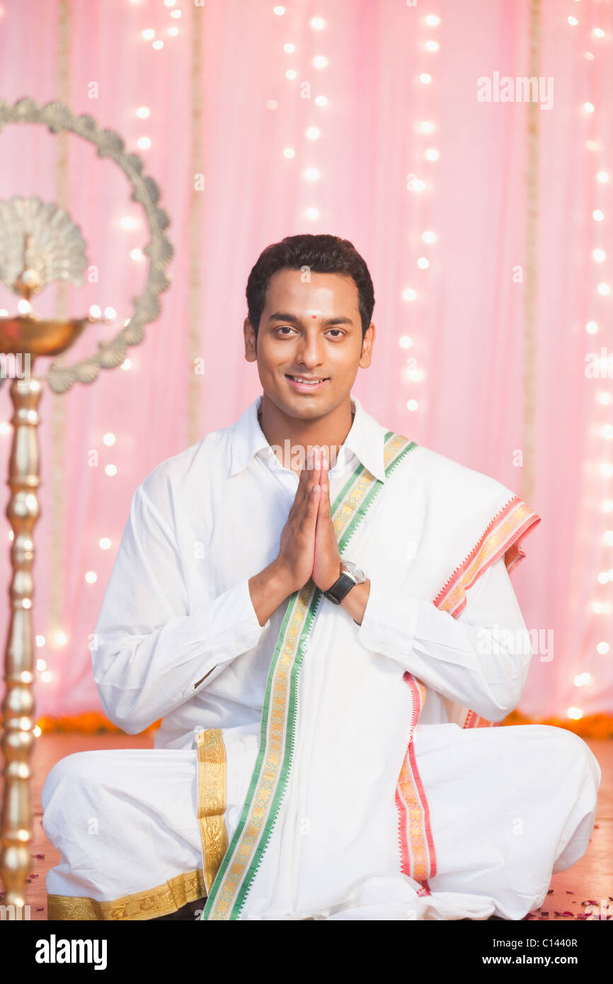 Uomo che prega nel sud tradizionale abito indiano Foto Stock