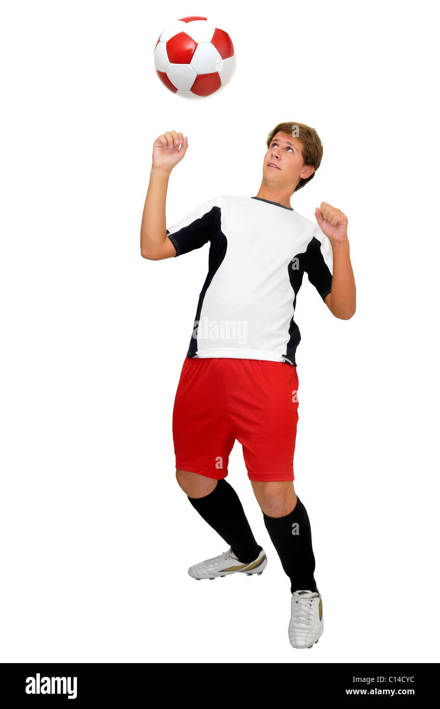Giovane calciatore con una sfera isolato in bianco Foto Stock
