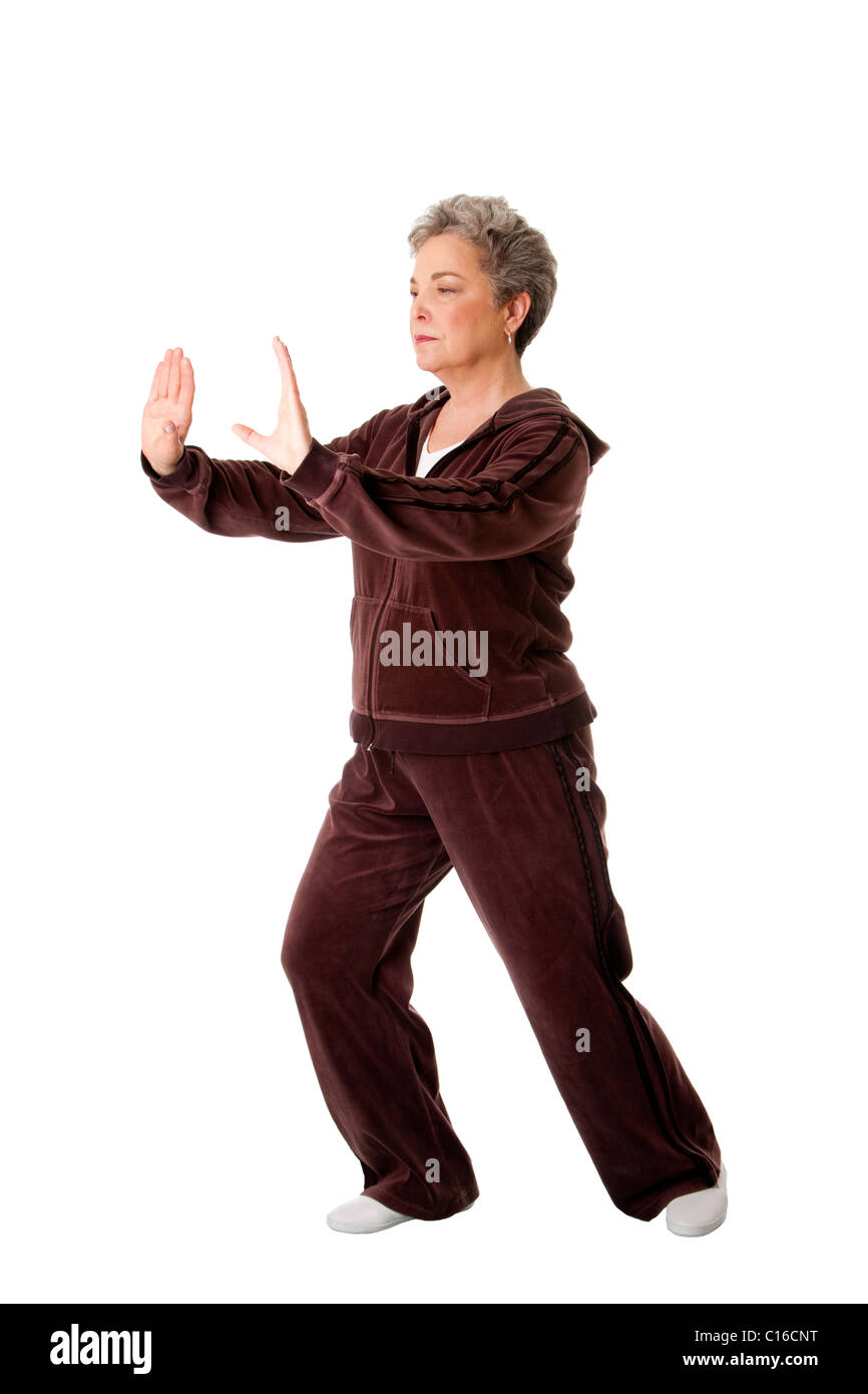 Bella donna Senior facendo Tai Chi esercizio per tenere la sua articolazioni flessibile, isolata. Foto Stock
