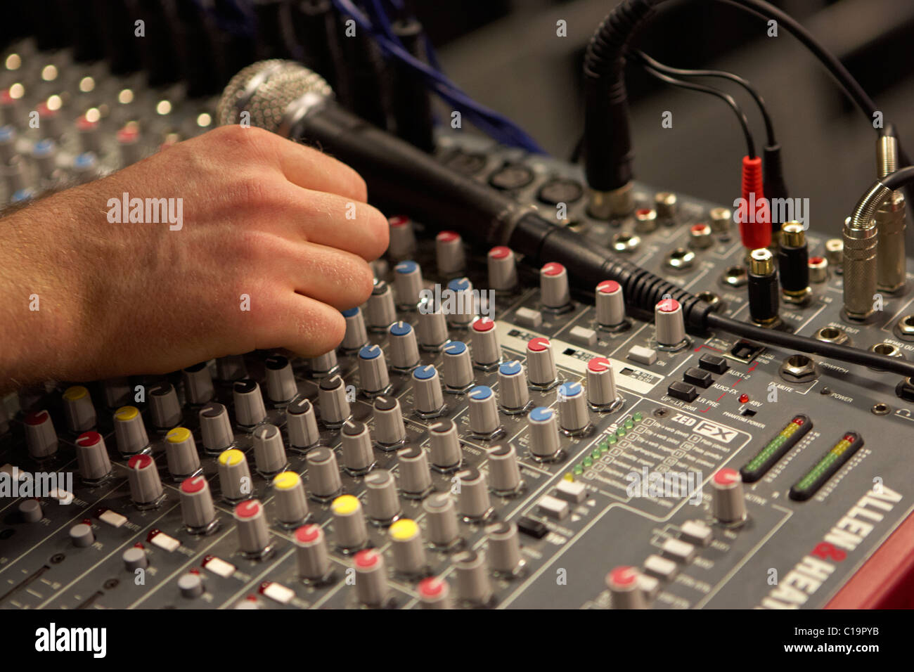 Ingegnere del suono il tweaking pan pentole su un mixaggio audio scrivania in un teatro concert hall Foto Stock