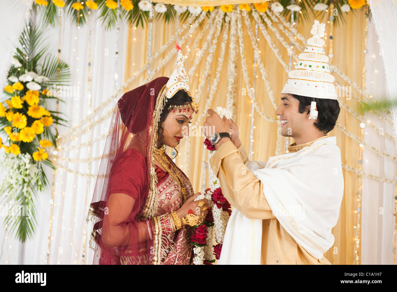 Paio di eseguire la mala (Badal Garland scambiare) cerimonia di nozze in Bengali Foto Stock