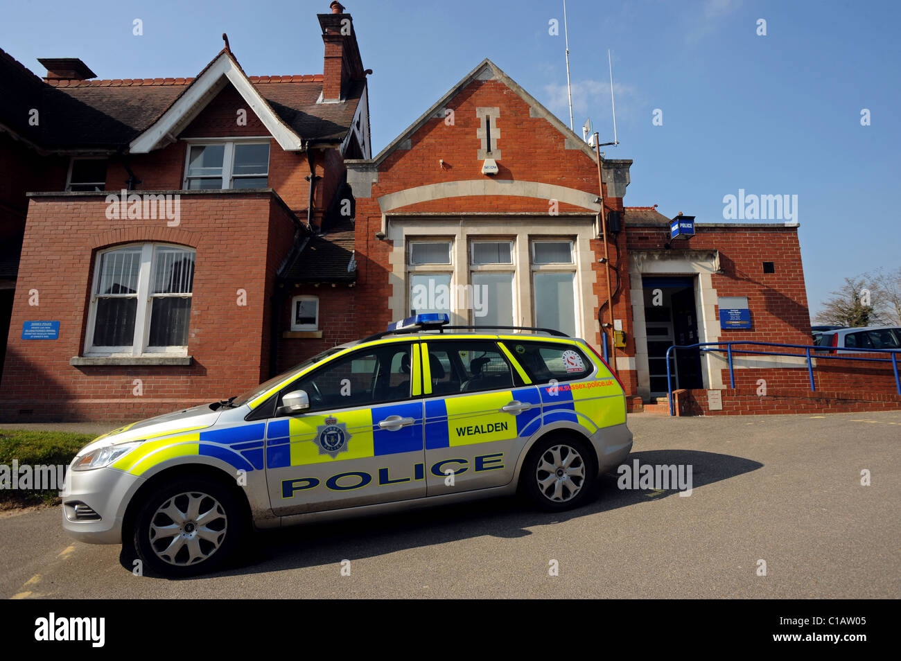 Una macchina della polizia si trova al di fuori di una piccola stazione di polizia nella città di Uckfield Foto Stock