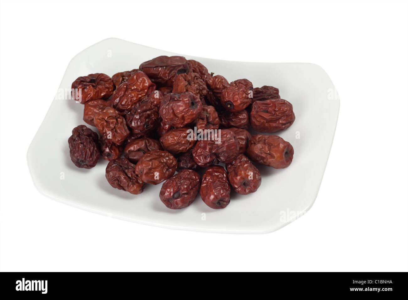 Ingrediente utilizzato nella medicina tradizionale cinese isolati su sfondo bianco - rosso secco Jujube Foto Stock