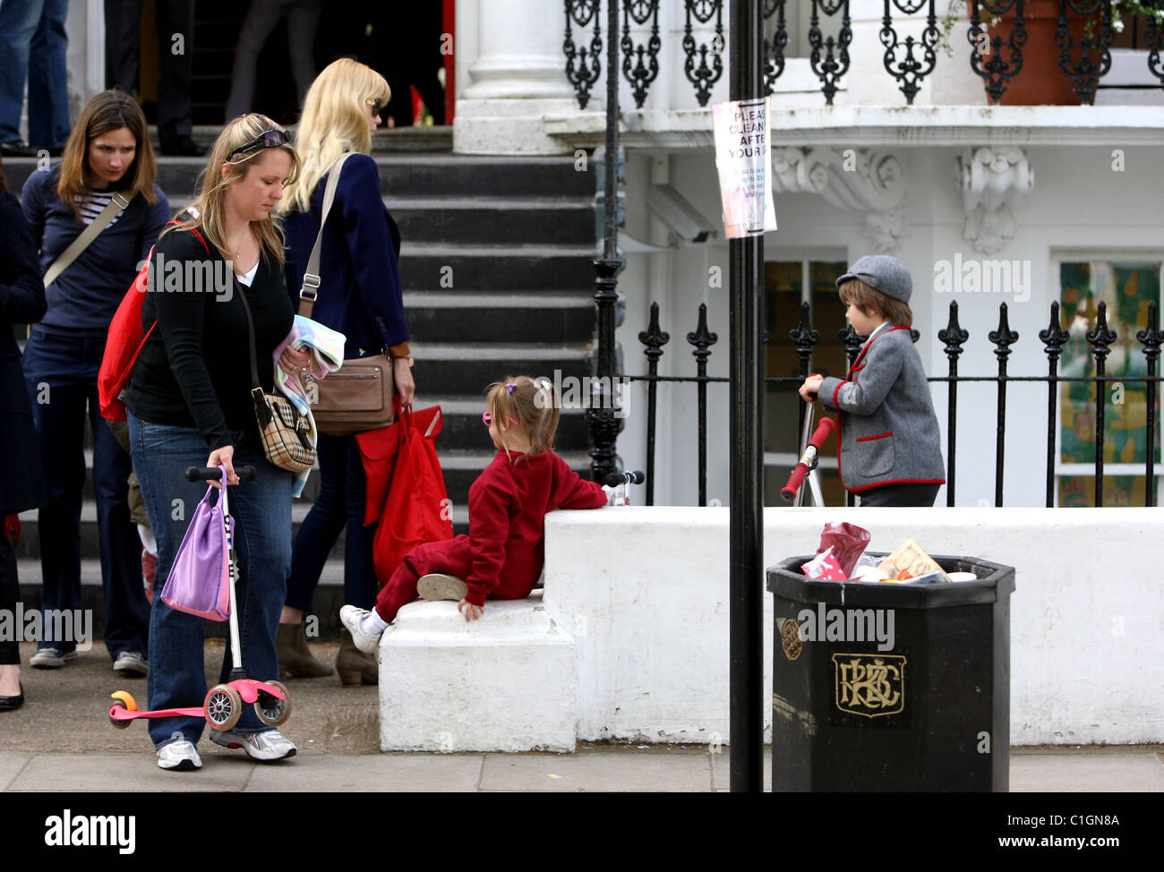 Claudia Schiffer la caduta di suo figlio Casper off a scuola Casper sembrano riluttanti a immettere la scuola senza il suo scooter, Londra Foto Stock