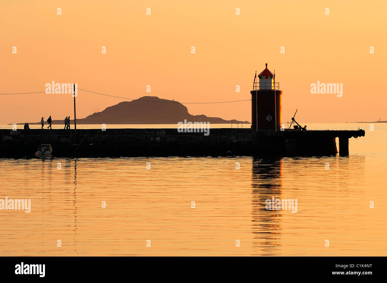 Norvegia, More og Romsdal, faro del porto di Alesund a il sole di mezzanotte Foto Stock