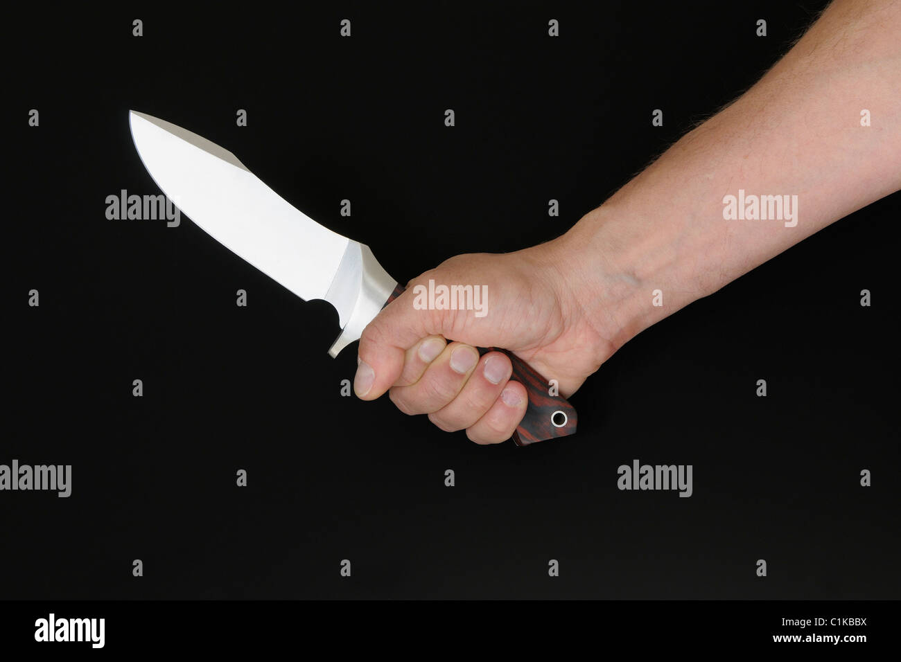 Mano che tiene il coltello Foto Stock
