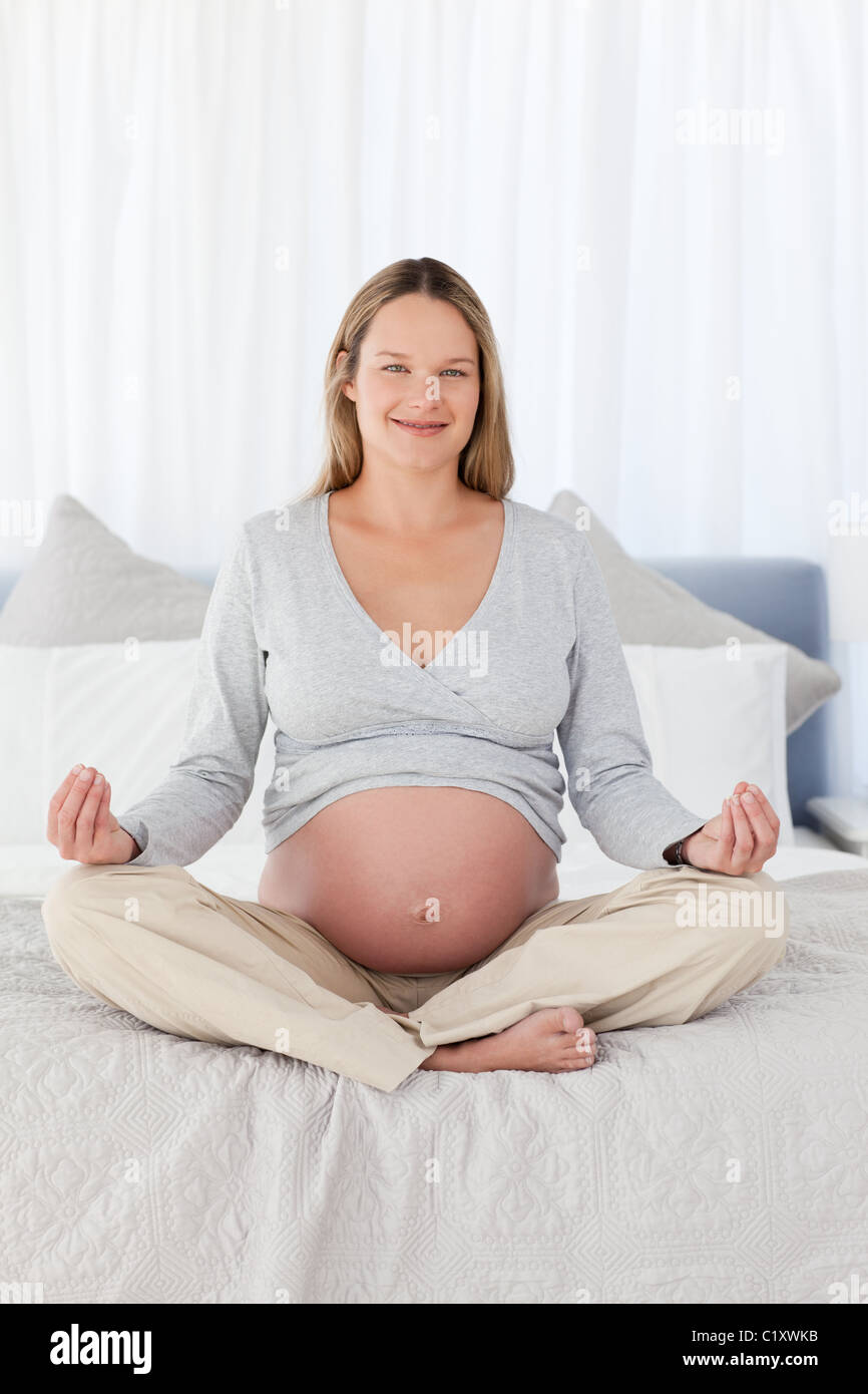 Bella donna incinta fare yoga Foto Stock