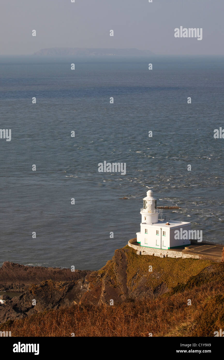 Hartland Point Lighthouse, con Lundy Island in distanza. Devon Foto Stock