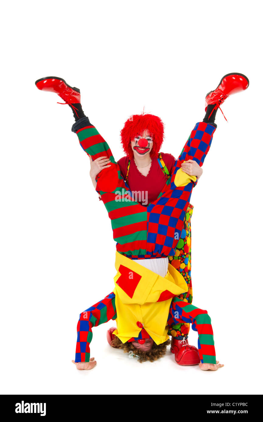 Giovane divertente pieno vestito clown capovolto Foto Stock
