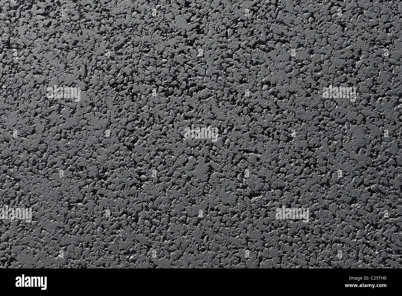 Nuovo black tarmac superficie stradale close up astratto sfondo texture. Foto Stock