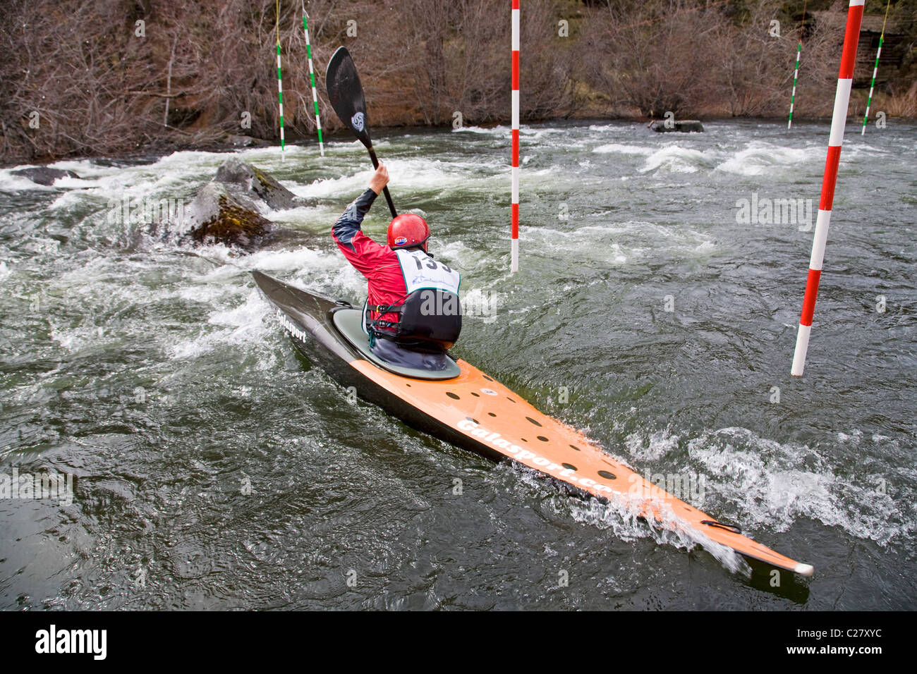 Un kayaker corre un difficile corso di kayak sul fiume Deschutes in curva, Oregon Foto Stock