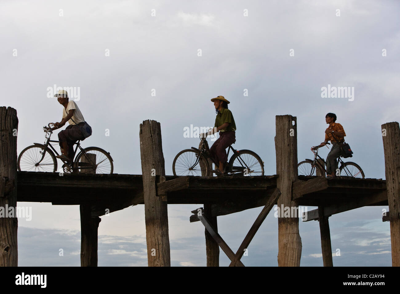 Amarapura, Myanmar, persone pedalare attraverso U Bein Bridge Foto Stock