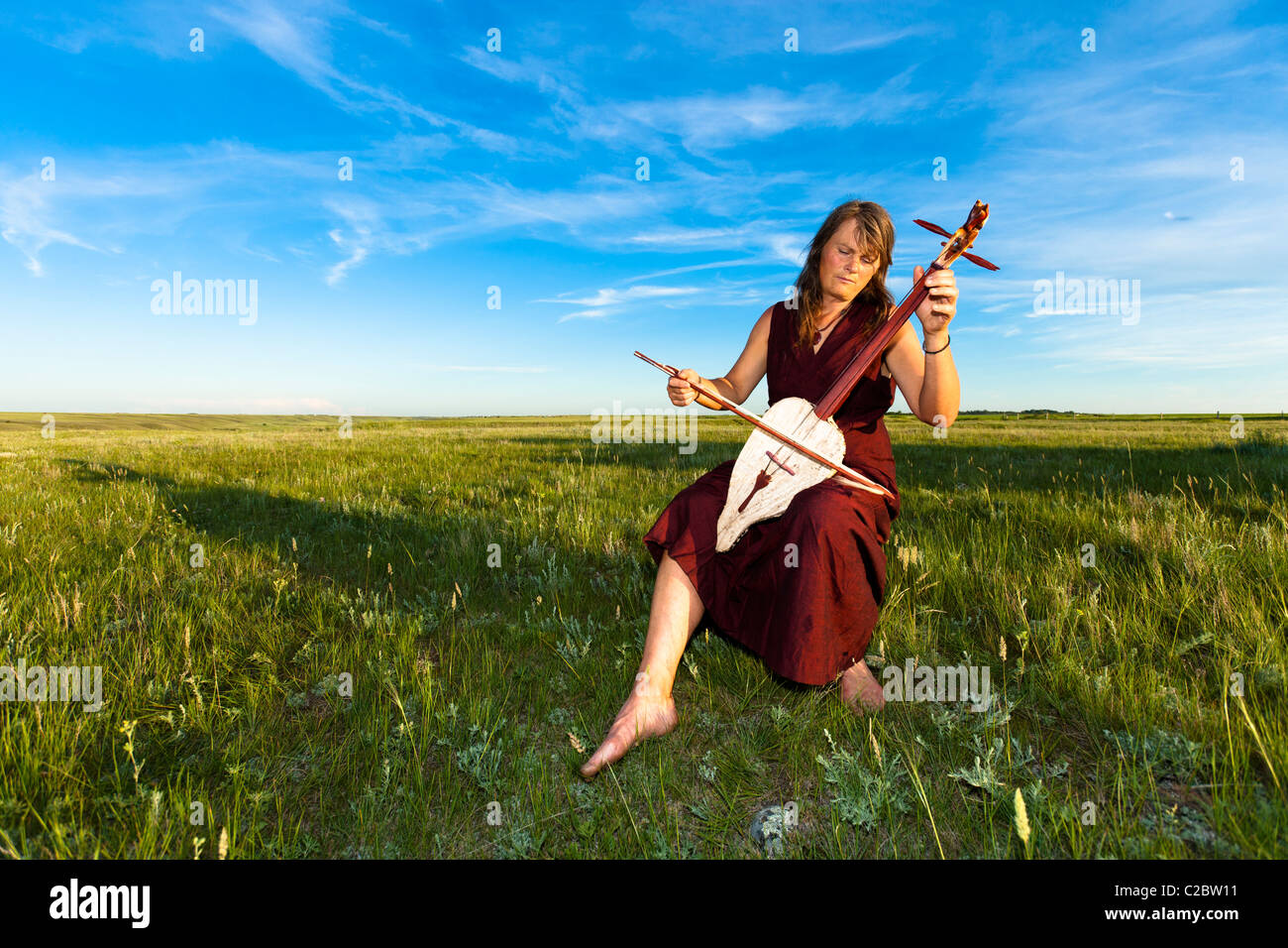 Donna che gioca un Igli. La Igli è un due strumenti a corda fatta da una zucca, bison nascondi tavola armonica e peli di cavallo stringhe. Foto Stock