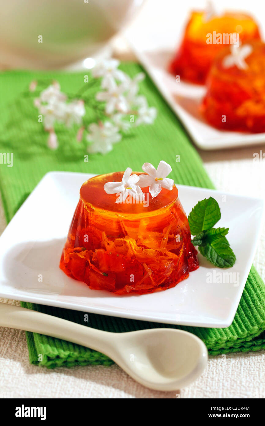 La gelatina con bacche rosse e fiori di gelsomino. Ricetta disponibile. Foto Stock